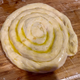 Completed dough coil, brushed with garlic oil